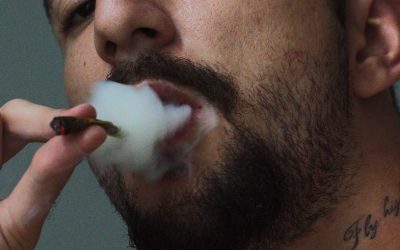 Man smokes weed and needs help from marijuana intervention program like the one at Waterford Counseling