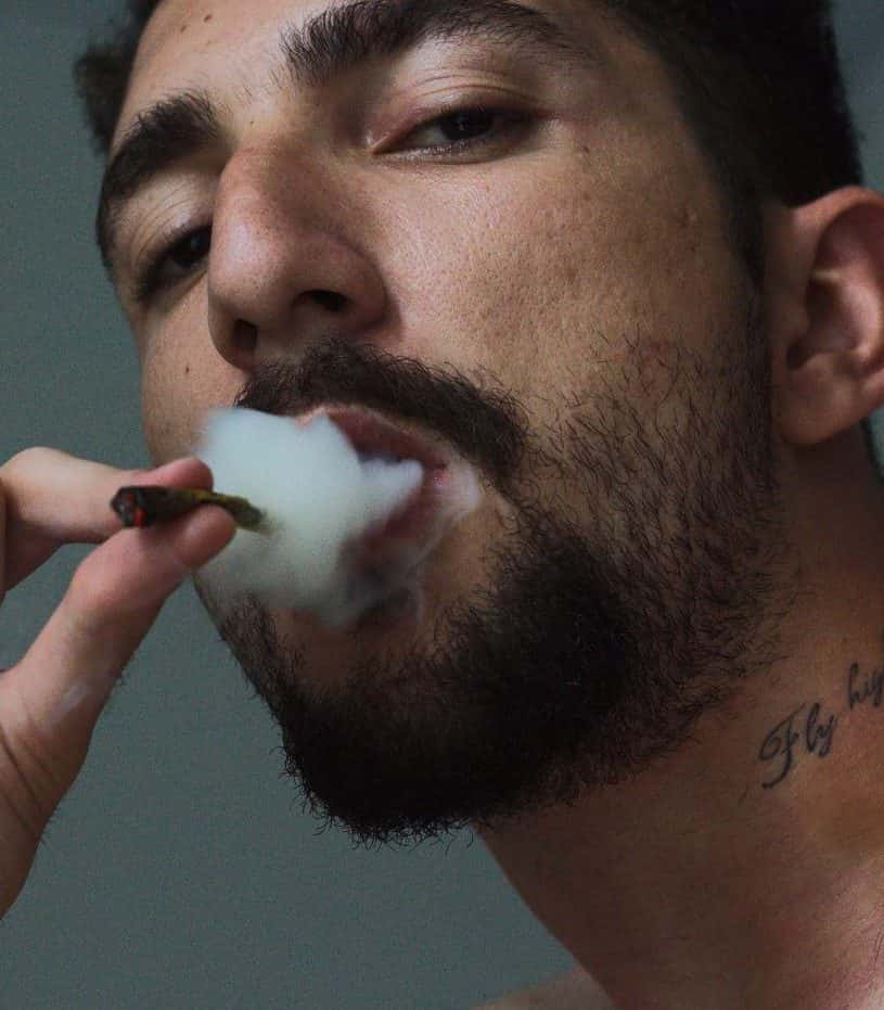 Man smokes weed and needs help from marijuana intervention program like the one at Waterford Counseling